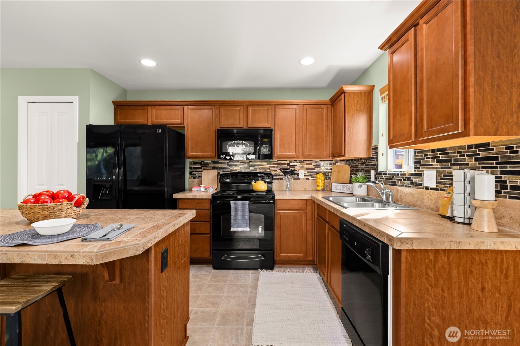 24002 Southeast 262nd Street Maple Valley, WA 98038 - Photo 12 of 30 a kitchen with stainless steel appliances granite countertop a sink stove and refrigerator