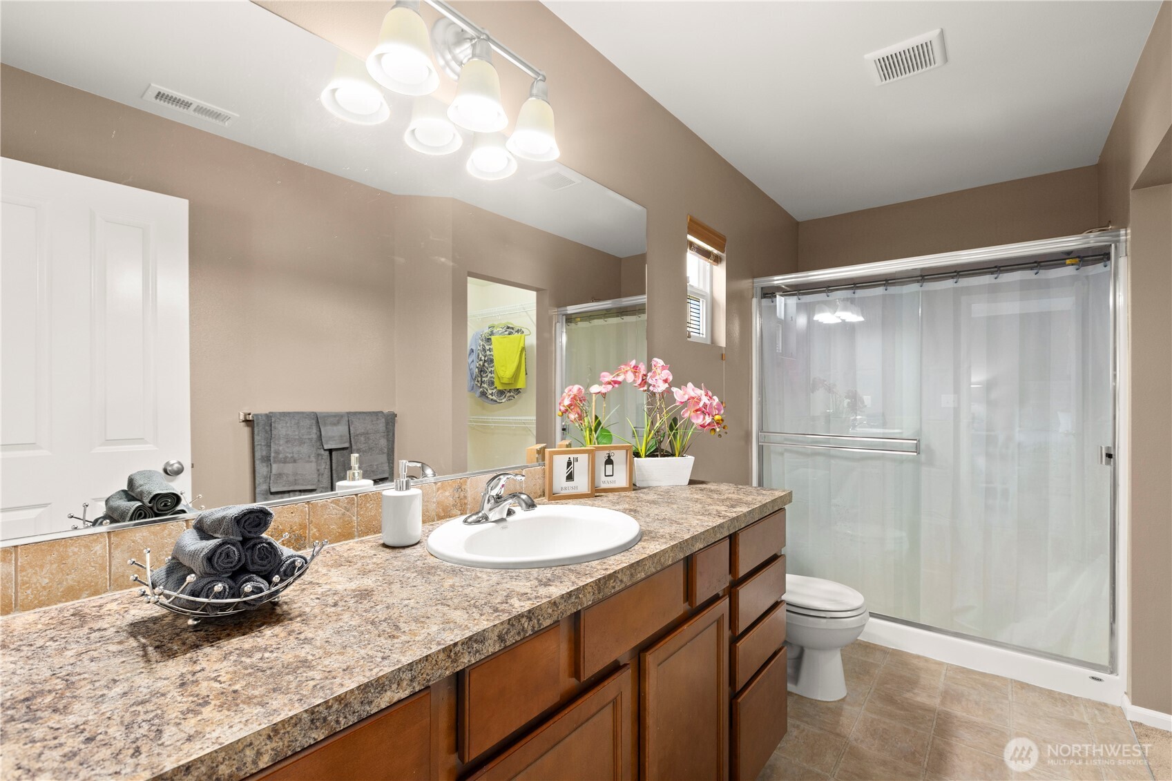 24002 Southeast 262nd Street Maple Valley, WA 98038 - Photo 17 of 30 a bathroom with a granite countertop sink a toilet and a mirror
