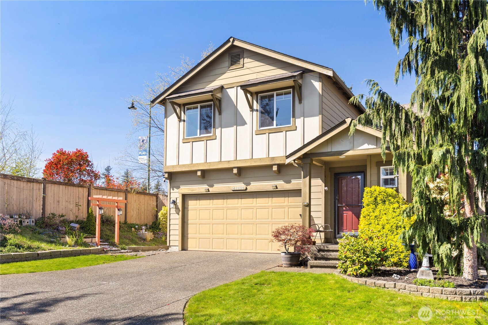 24002 Southeast 262nd Street Maple Valley, WA 98038 - Photo 24 of 30 a front view of a house with a yard