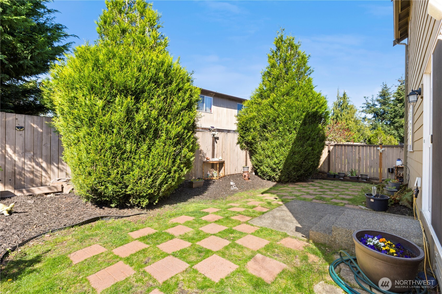 24002 Southeast 262nd Street Maple Valley, WA 98038 - Photo 25 of 30 a view of a backyard with plants and a small yard
