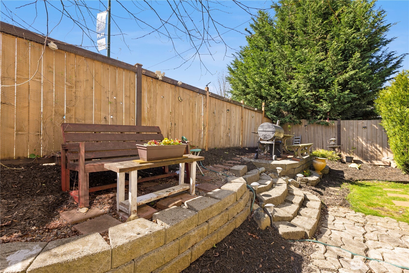24002 Southeast 262nd Street Maple Valley, WA 98038 - Photo 27 of 30 a view of a backyard with chairs and a fire pit