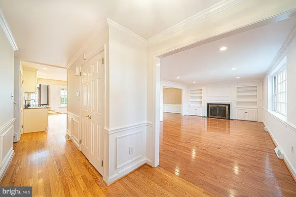 a view of a hallway view with wooden floor and windows