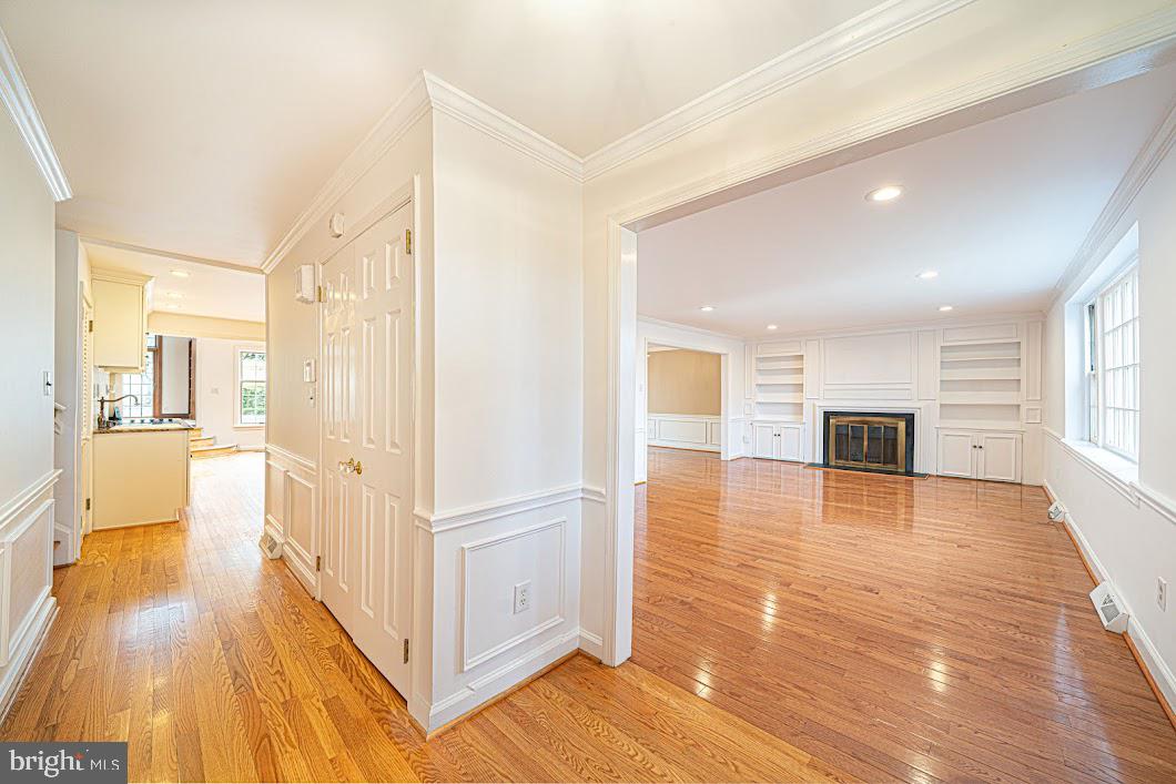 a view of a hallway view with wooden floor and windows