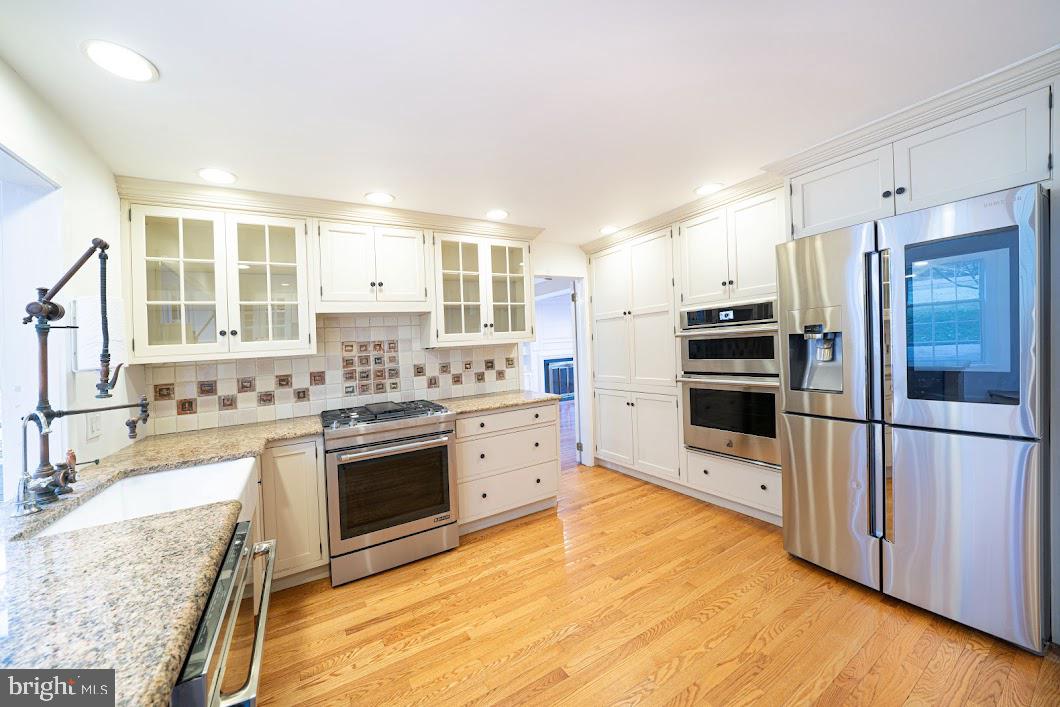 642 Pugh Road Wayne, PA 19087 - Photo 11 of 65 a kitchen with stainless steel appliances granite countertop a stove a sink and a refrigerator
