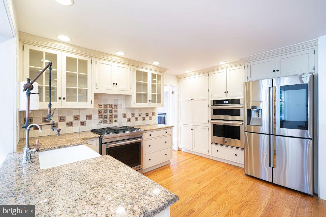 642 Pugh Road Wayne, PA 19087 - Photo 12 of 65 a kitchen with stainless steel appliances granite countertop a refrigerator sink stove and oven