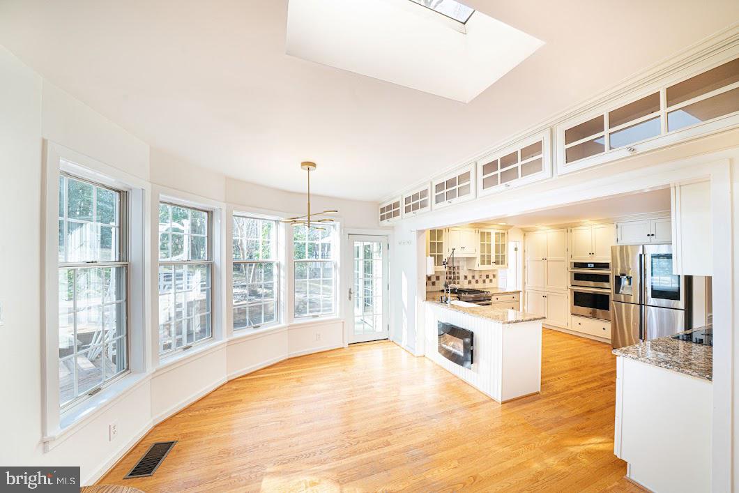 642 Pugh Road Wayne, PA 19087 - Photo 14 of 65 a large white kitchen with cabinets a sink and wooden floor