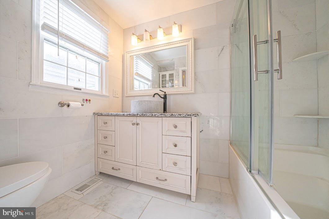 642 Pugh Road Wayne, PA 19087 - Photo 28 of 65 a bathroom with a granite countertop sink mirror and a bathtub