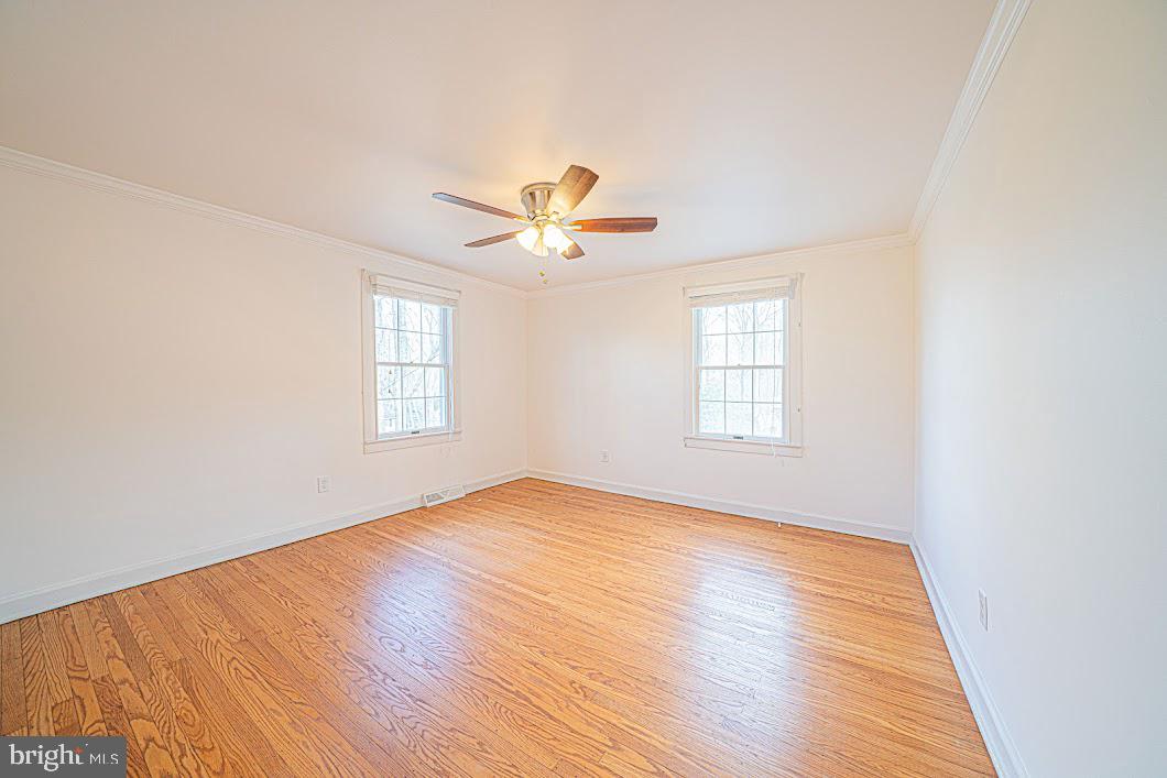 642 Pugh Road Wayne, PA 19087 - Photo 29 of 65 an empty room with wooden floor and windows