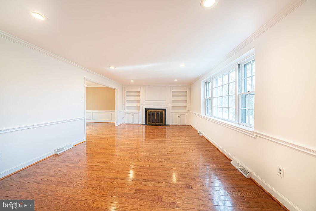642 Pugh Road Wayne, PA 19087 - Photo 3 of 65 a view of empty room with wooden floor and fireplace