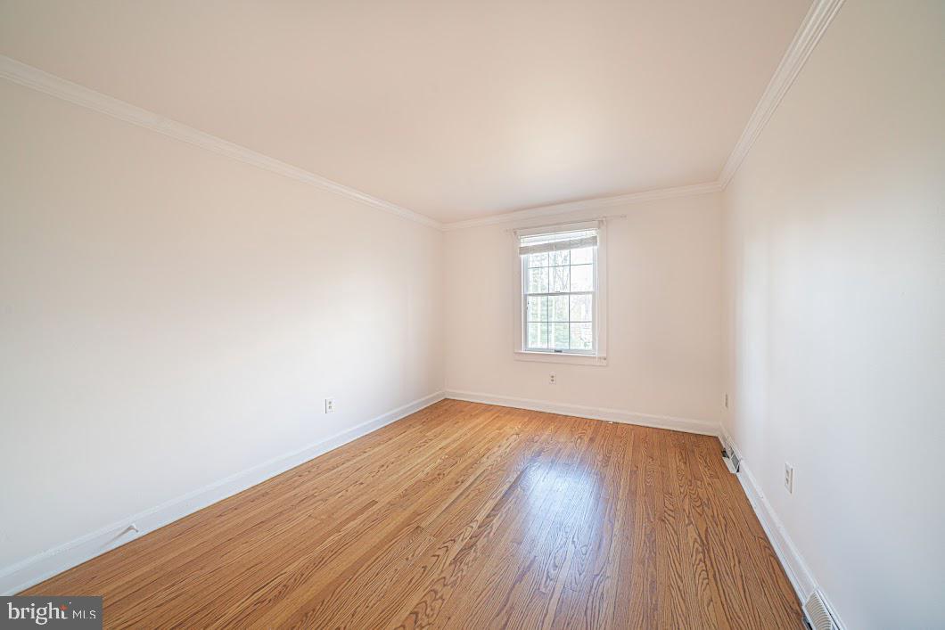 642 Pugh Road Wayne, PA 19087 - Photo 31 of 65 an empty room with wooden floor and windows