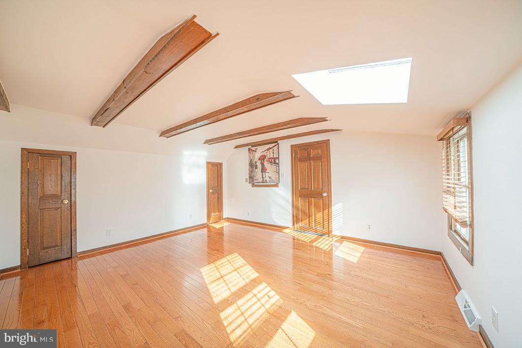 642 Pugh Road Wayne, PA 19087 - Photo 37 of 65 a view of an empty room with window and wooden floor