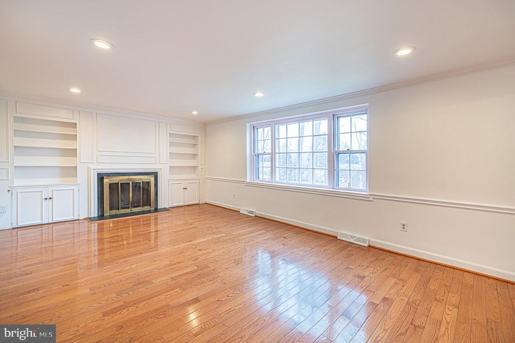 642 Pugh Road Wayne, PA 19087 - Photo 4 of 65 an empty room with wooden floor and fireplace