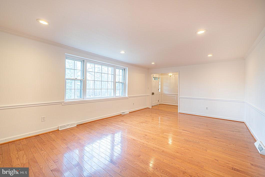 642 Pugh Road Wayne, PA 19087 - Photo 5 of 65 a view of an empty room with wooden floor and a window