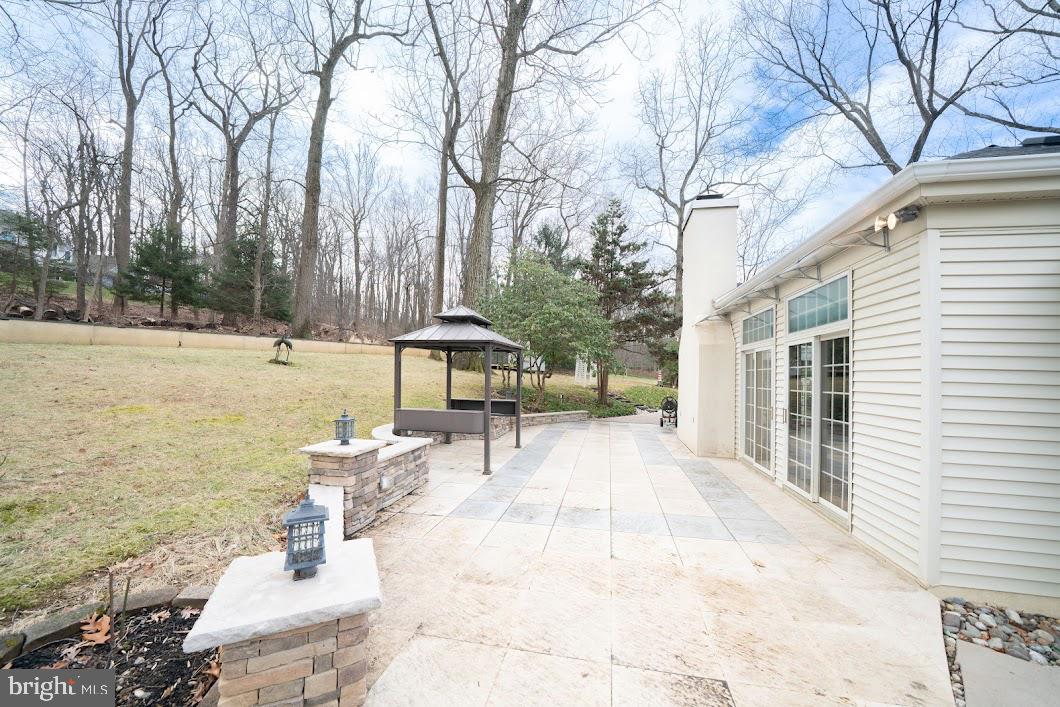 642 Pugh Road Wayne, PA 19087 - Photo 61 of 65 a view of a patio with table and chairs under an umbrella