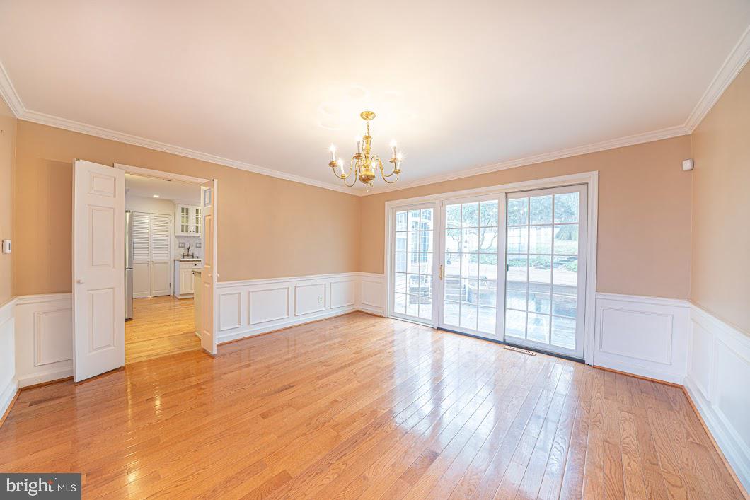 642 Pugh Road Wayne, PA 19087 - Photo 7 of 65 a view of an empty room with wooden floor and a window