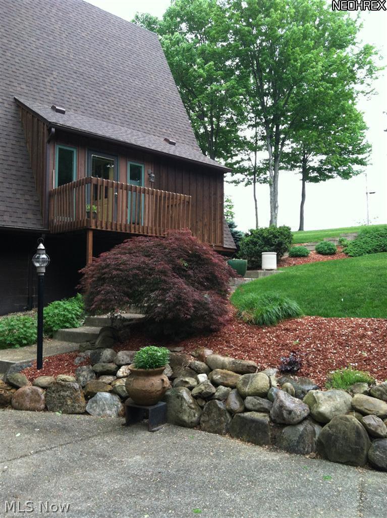 5838 Fairland Road Clinton, OH 44216 - Photo 4 of 25 ENTRY OF HOUSE - NEWER CONCRETE STAIRS - LANDSCAPED AREAS WITH BEDS AND PERENNIAL PLANTINGS - REGRADED - DRIVEWAY