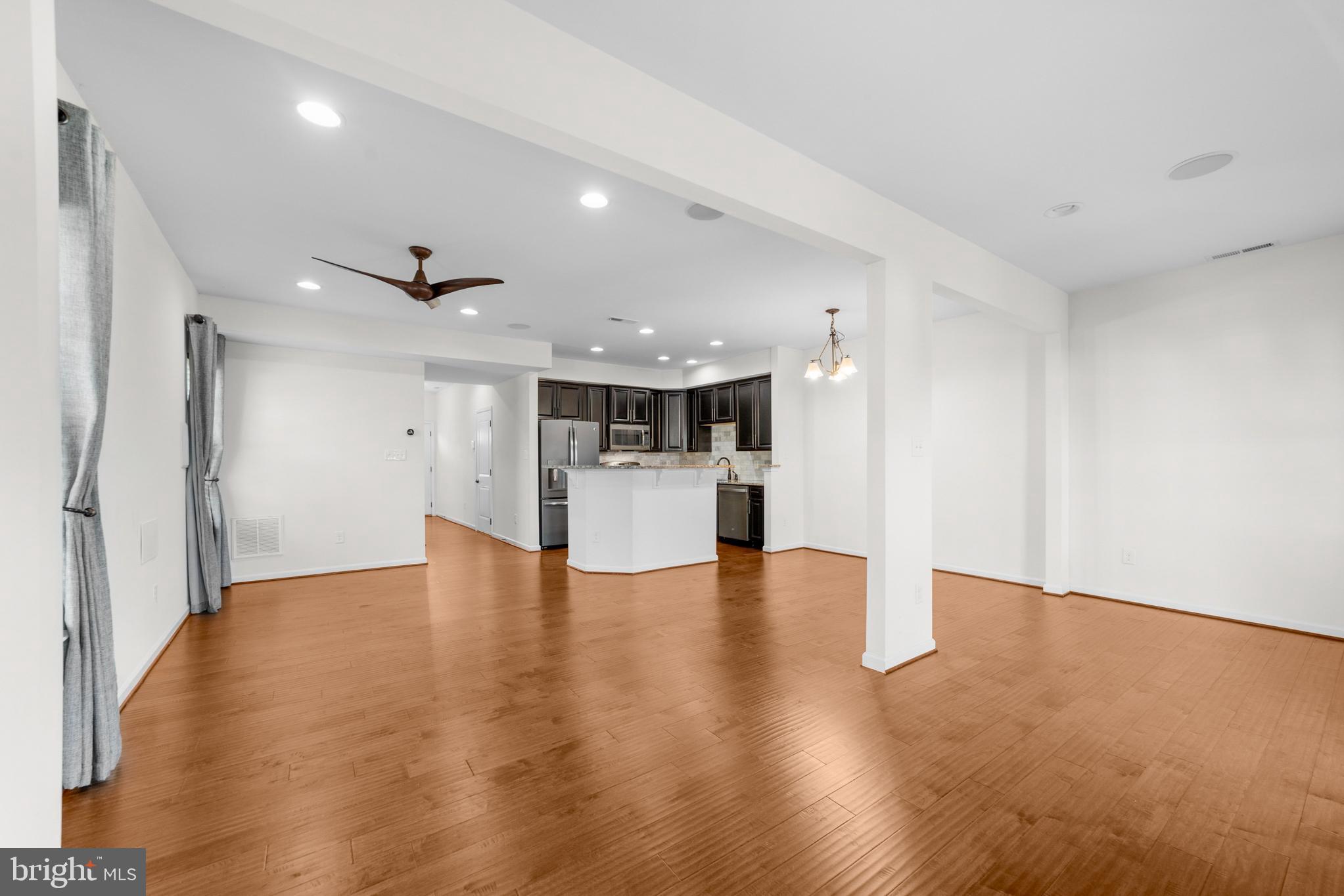 42 Sundance Drive Hamilton, NJ 08619 - Photo 13 of 25 a view of an empty room with wooden floor and a kitchen