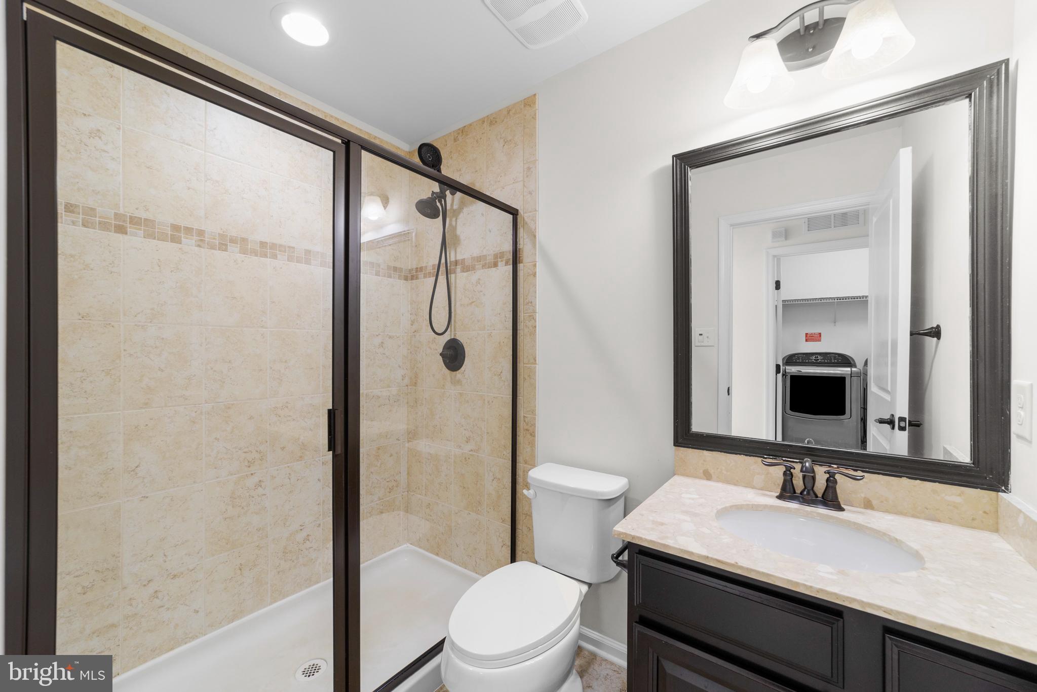 42 Sundance Drive Hamilton, NJ 08619 - Photo 19 of 25 a bathroom with a sink a toilet a mirror and shower