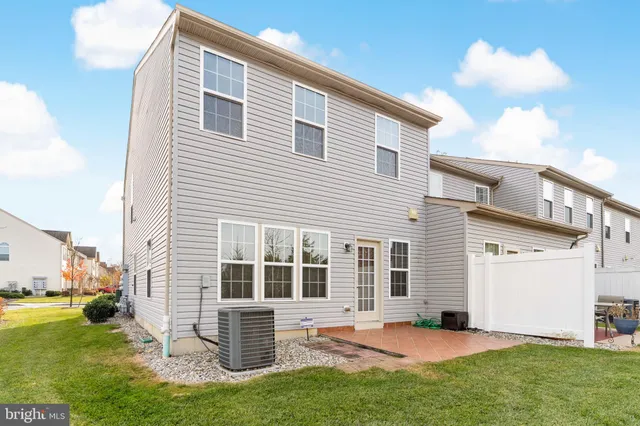 a backyard of a house with garden and barbeque oven