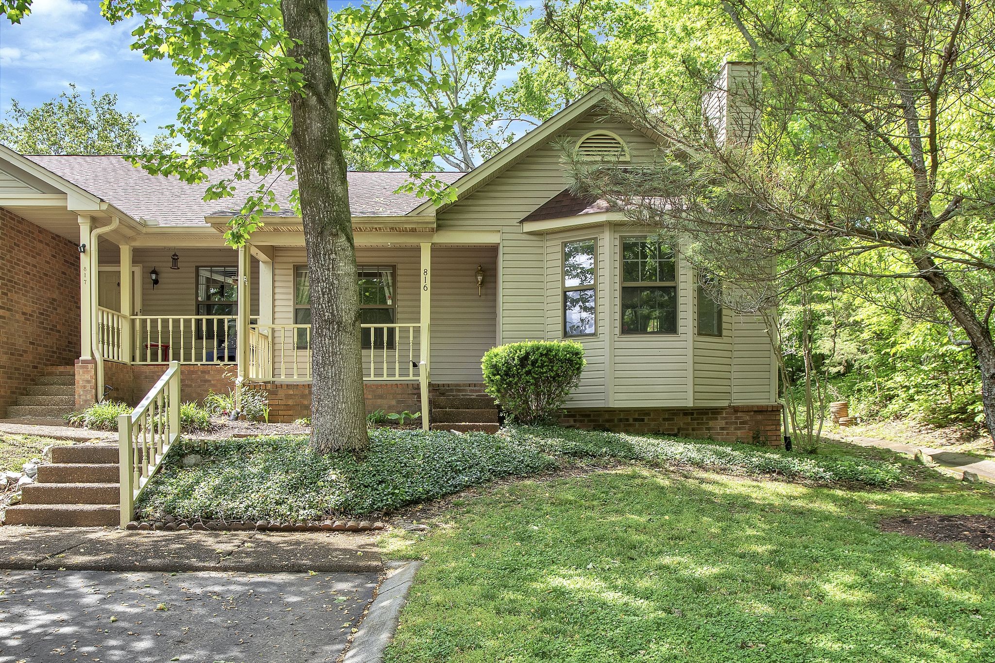 a front view of a house with a garden