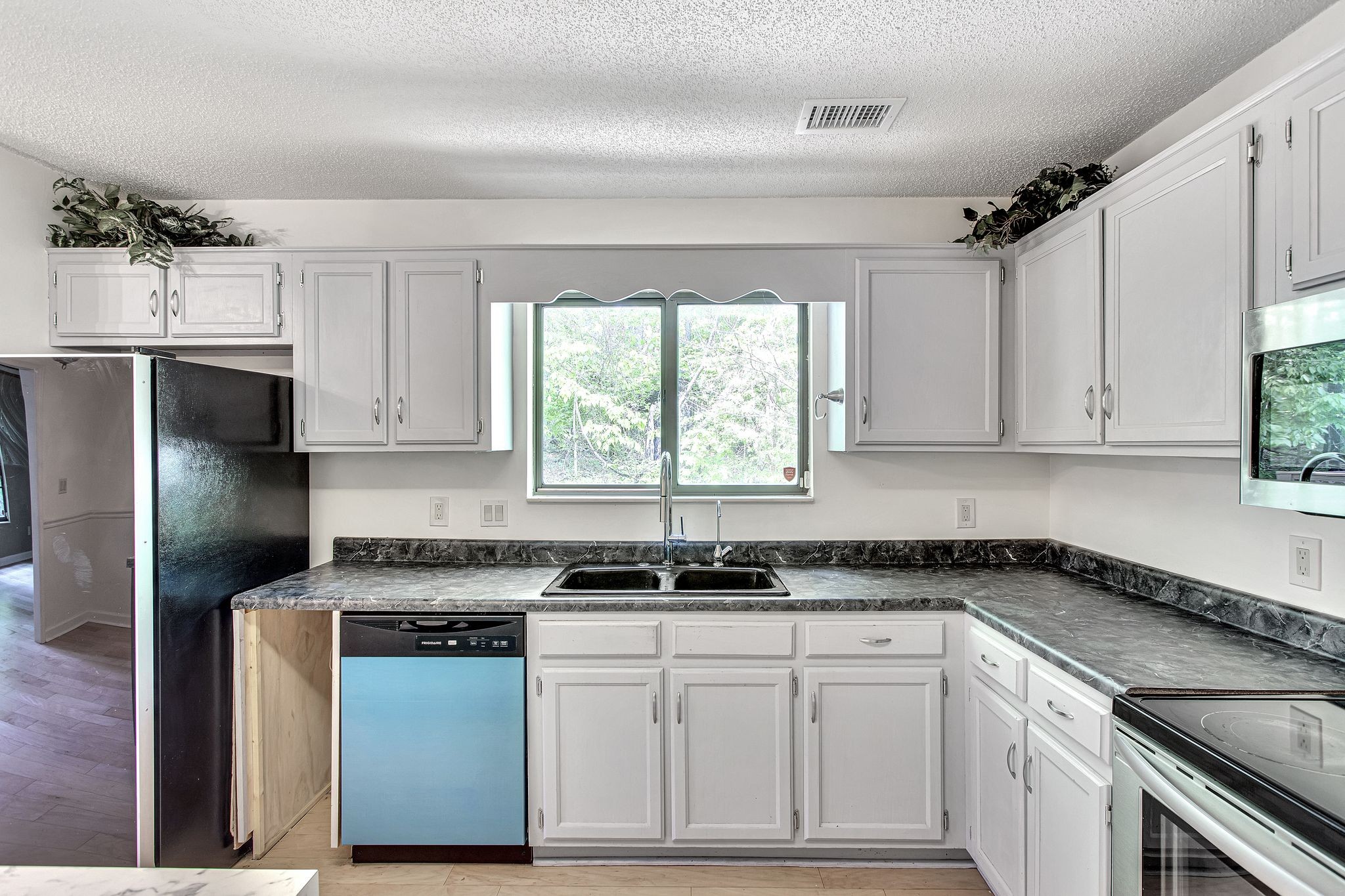 816 Beazer Lane Antioch, TN 37013 - Photo 15 of 32 a kitchen with granite countertop a sink stainless steel appliances a window and cabinets