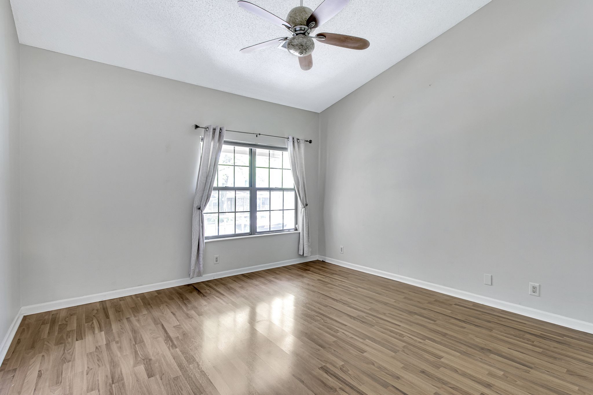 816 Beazer Lane Antioch, TN 37013 - Photo 25 of 32 an empty room with wooden floor chandelier fan and windows