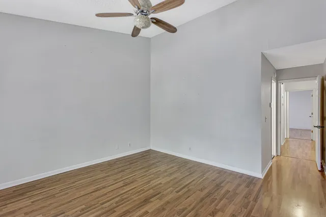 a view of a room with wooden floor and white walls