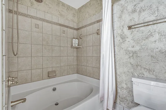 a bathroom with a bathtub and a shower