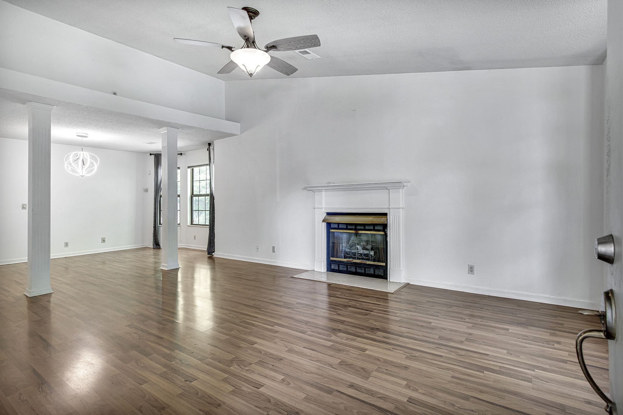 816 Beazer Lane Antioch, TN 37013 - Photo 6 of 32 an empty room with wooden floor fireplace and windows