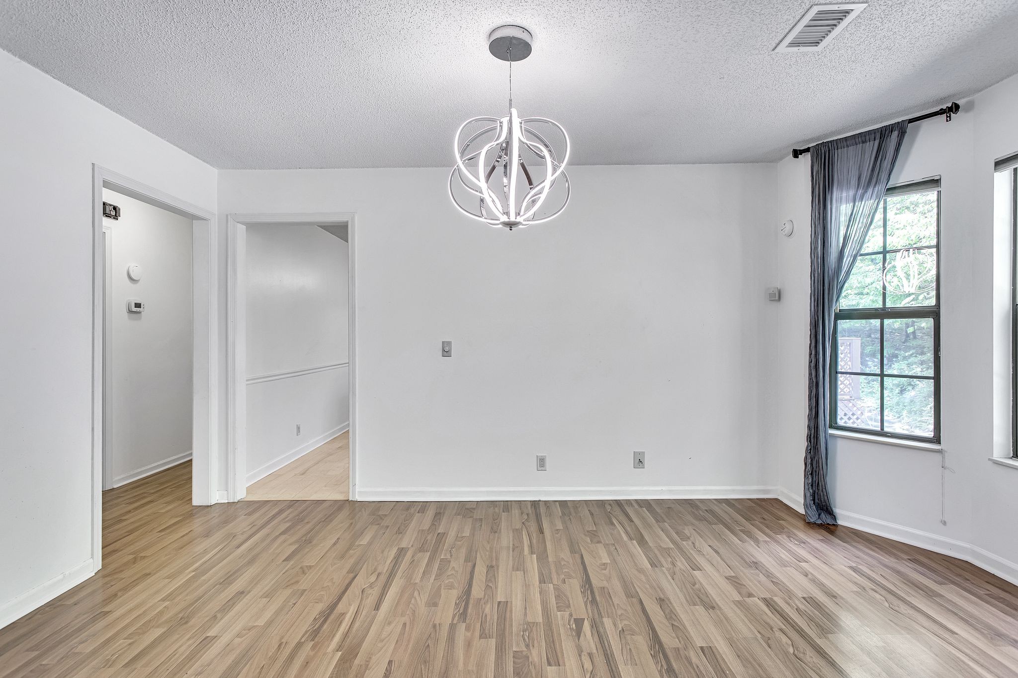 816 Beazer Lane Antioch, TN 37013 - Photo 10 of 32 an empty room with wooden floor and windows
