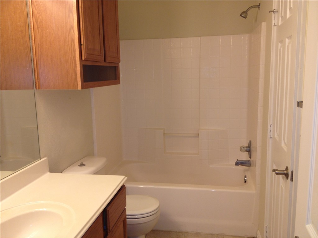 1001 Krenek Tap Road, Unit 1504 College Station, TX 77840 - Photo 4 of 8 a bathroom with a sink a toilet and shower