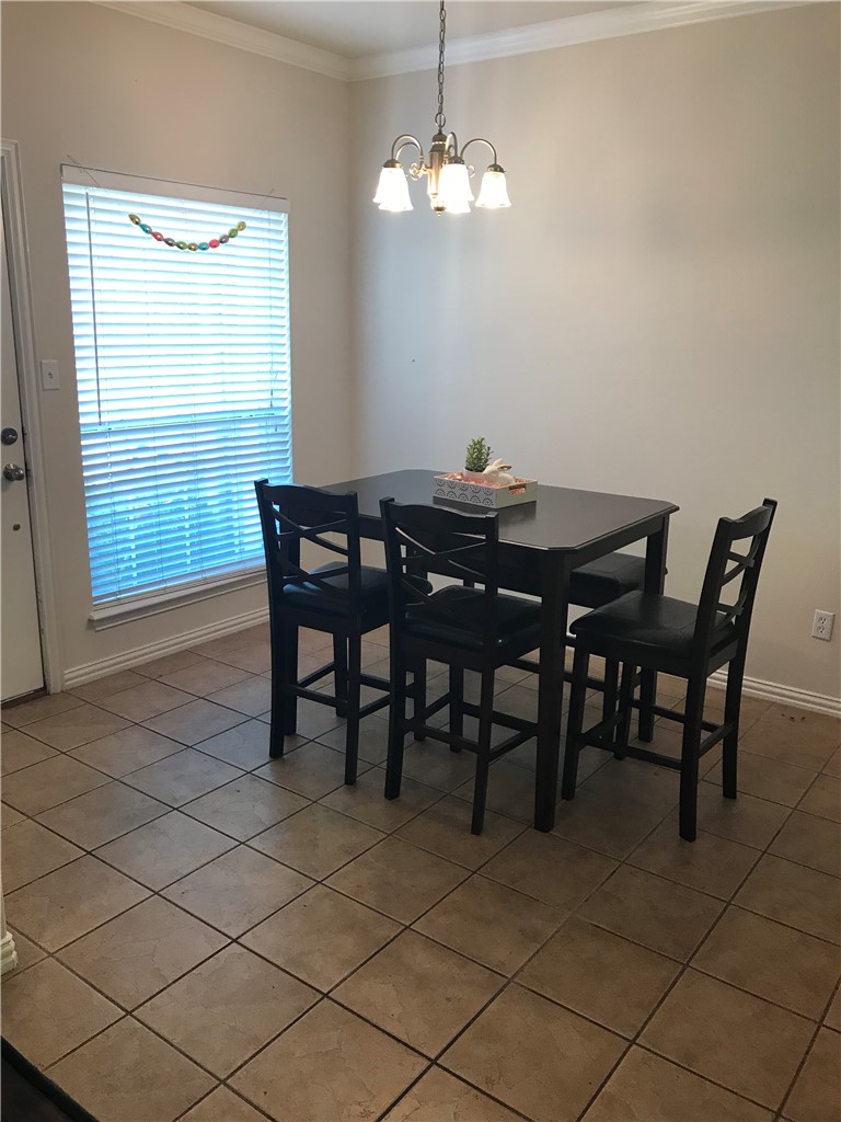 1001 Krenek Tap Road, Unit 1504 College Station, TX 77840 - Photo 5 of 8 a view of a dining room with furniture and a chandelier