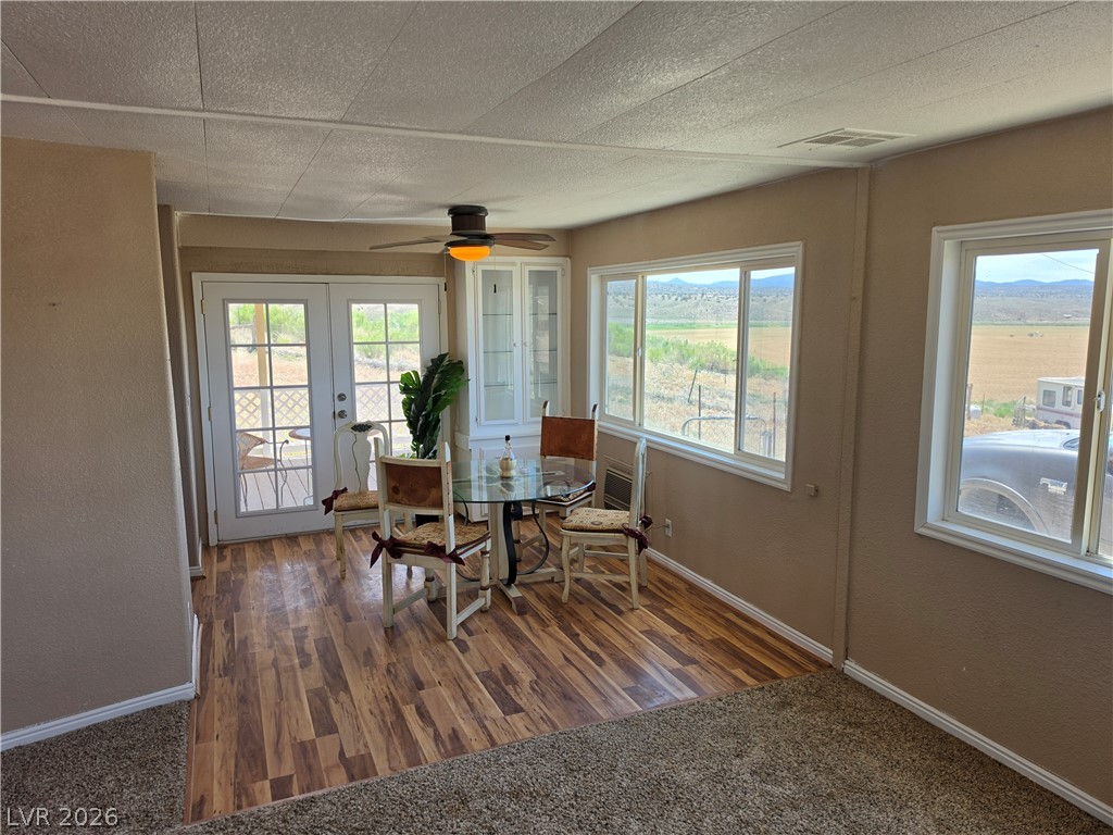 2930 Frehner Ranch Road Pioche, NV 89043 - Photo 38 of 39 French doors and broad windows frame the dining area, offering sweeping landscape views.