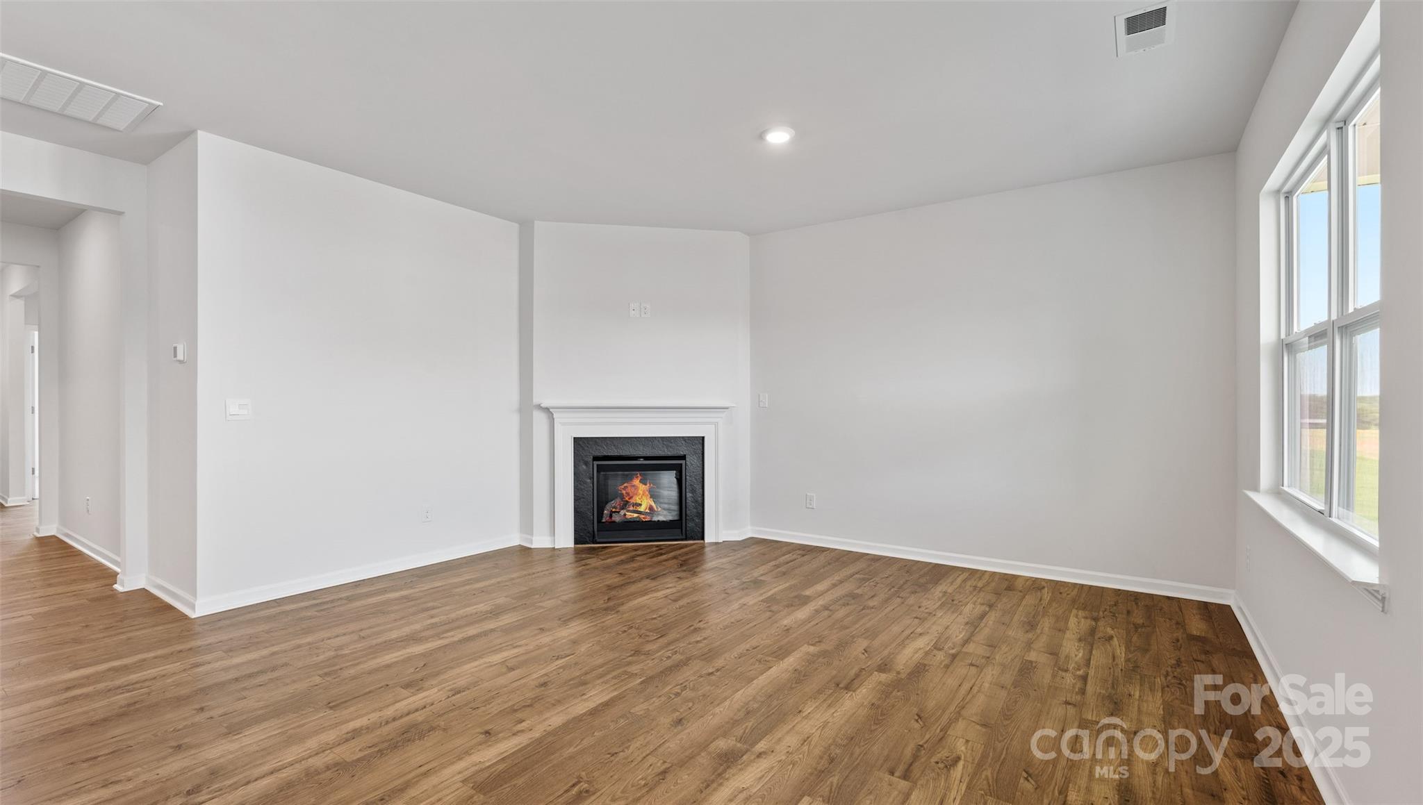 119 Bovine Br Road Fletcher, NC 28732 - Photo 11 of 29 wooden floor in an empty room with a fireplace