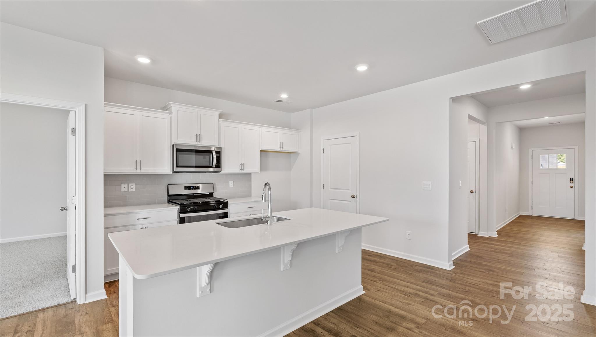 119 Bovine Br Road Fletcher, NC 28732 - Photo 9 of 29 a kitchen with stainless steel appliances a stove top oven a sink a refrigerator and cabinets