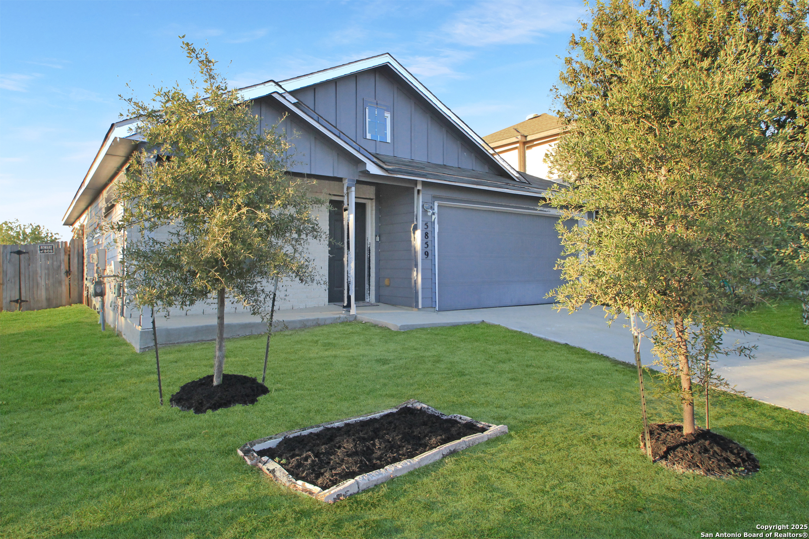 5859 Cielo Ranch San Antonio, TX 78218 - Photo 2 of 12 a backyard of a house with plants and wooden fence
