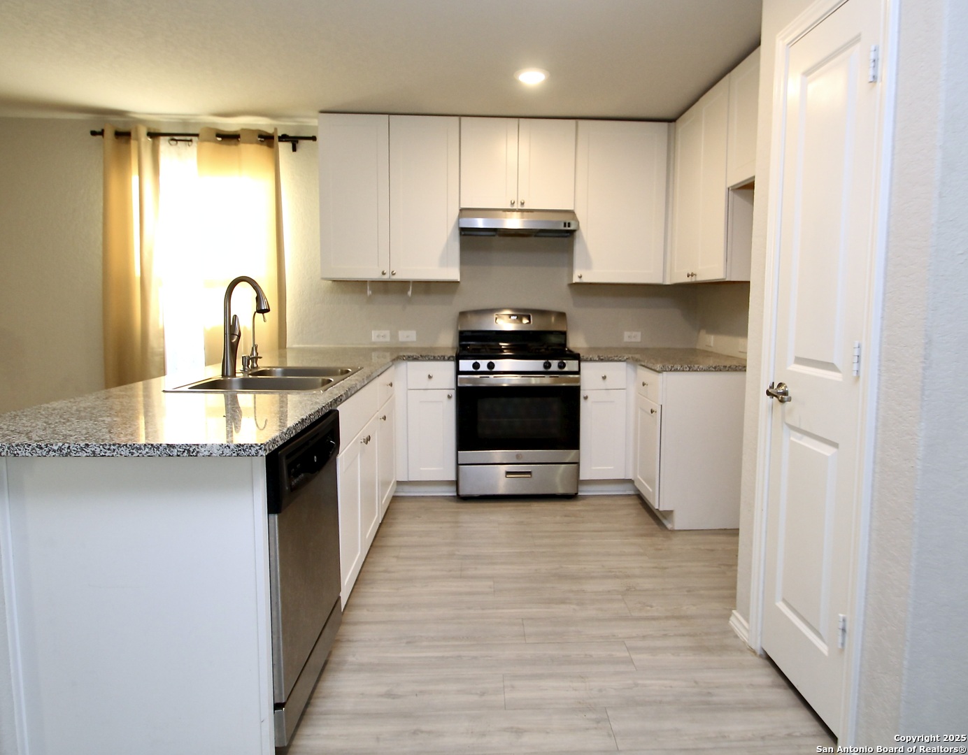 5859 Cielo Ranch San Antonio, TX 78218 - Photo 5 of 12 a kitchen with stainless steel appliances granite countertop a stove sink and cabinets