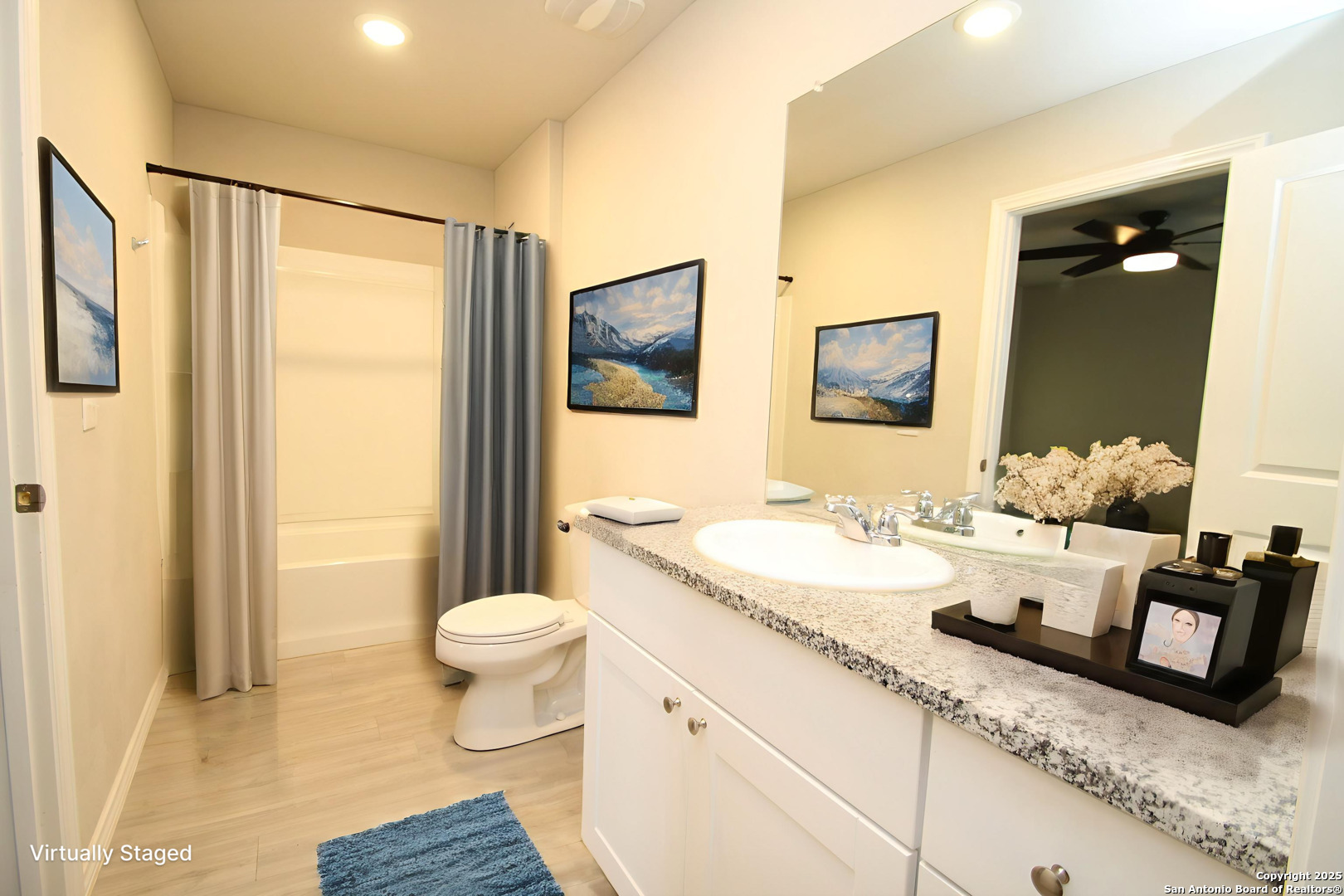 5859 Cielo Ranch San Antonio, TX 78218 - Photo 8 of 12 a bathroom with a granite countertop sink mirror vanity and toilet