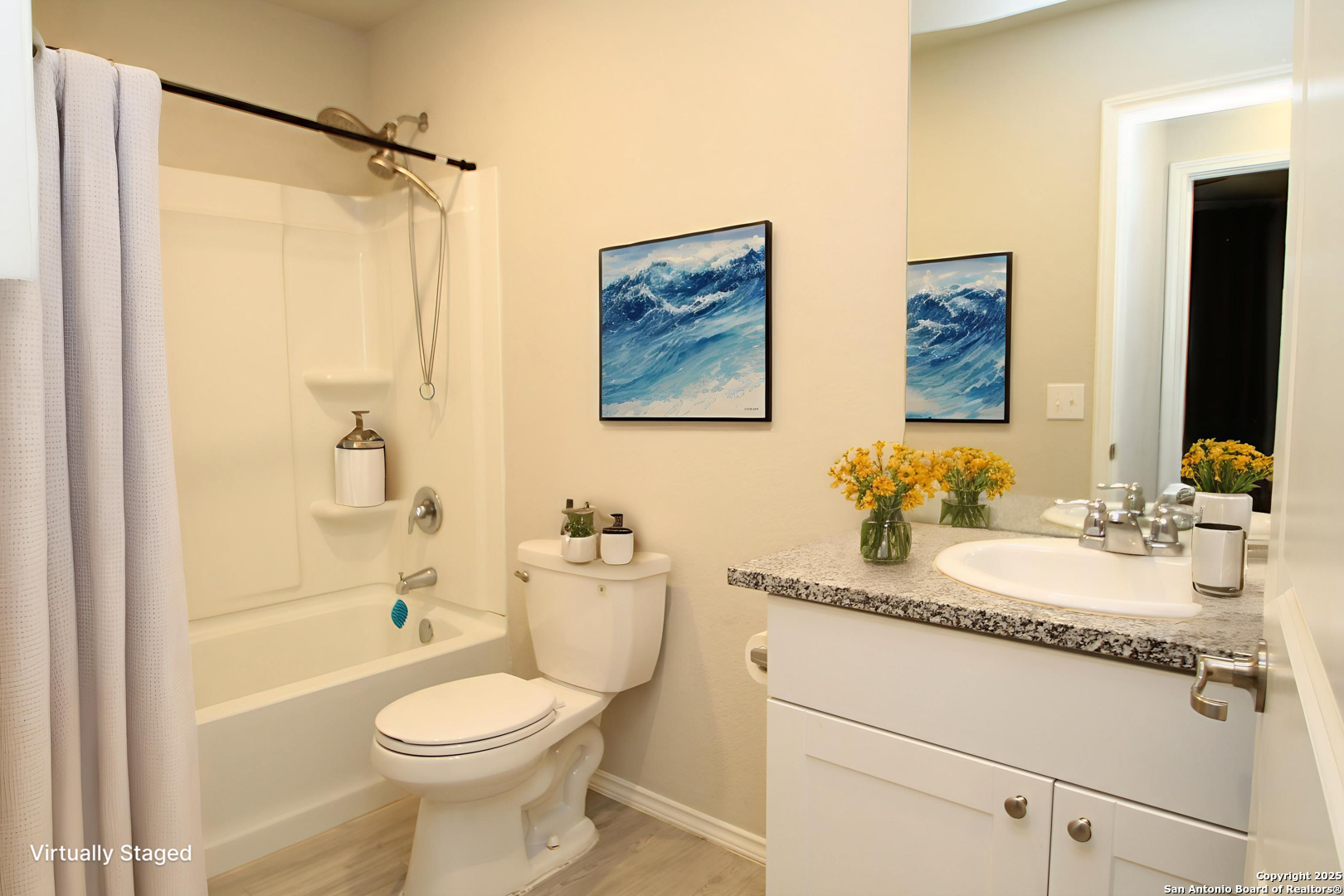 5859 Cielo Ranch San Antonio, TX 78218 - Photo 10 of 12 a bathroom with a granite countertop toilet sink and mirror