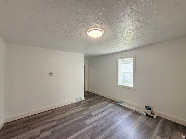 548 27th Street Ogden, UT 84403 - Photo 10 of 13 Spare room with a textured ceiling and wood finished floors