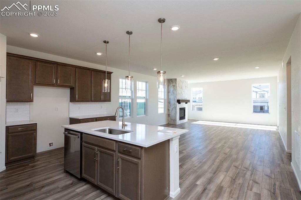 2057 Peachleaf Loop Castle Rock, CO 80108 - Photo 11 of 23 a kitchen with a sink cabinets and wooden floor