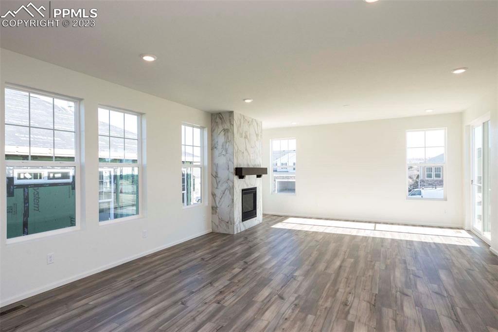 2057 Peachleaf Loop Castle Rock, CO 80108 - Photo 12 of 23 a view of an empty room with wooden floor and a window