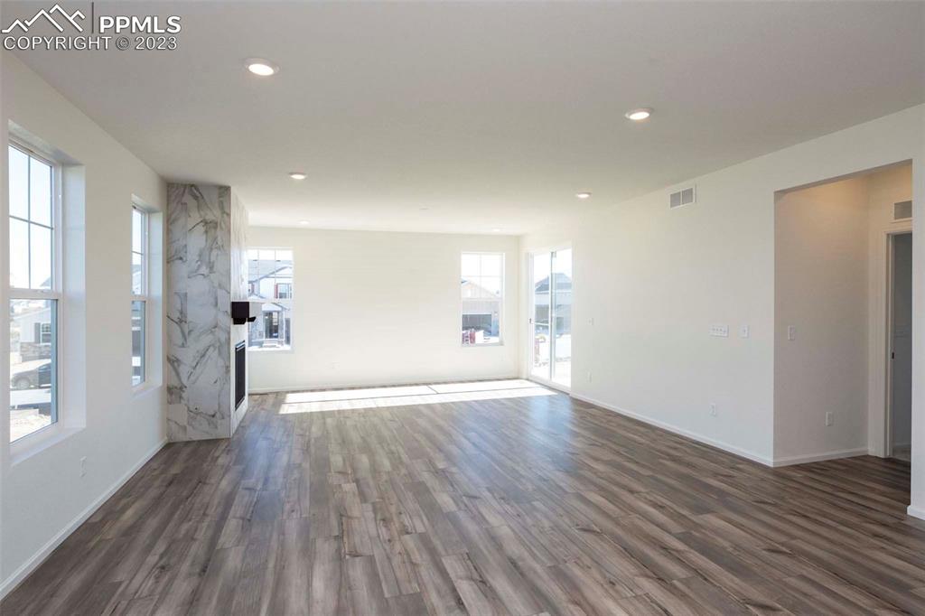 2057 Peachleaf Loop Castle Rock, CO 80108 - Photo 13 of 23 a view of a big room with wooden floor and windows