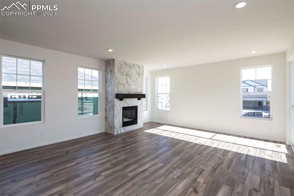 2057 Peachleaf Loop Castle Rock, CO 80108 - Photo 14 of 23 wooden floor fireplace and windows in an empty room