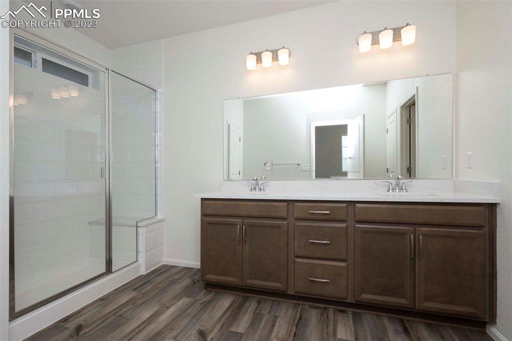 2057 Peachleaf Loop Castle Rock, CO 80108 - Photo 19 of 23 a bathroom with a double vanity sink and mirror