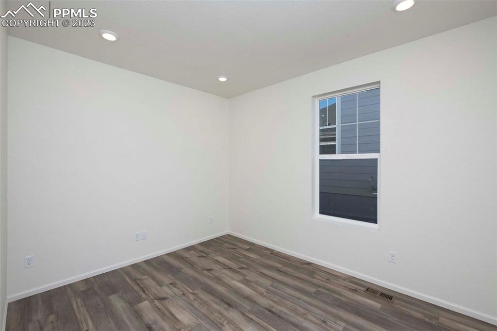 2057 Peachleaf Loop Castle Rock, CO 80108 - Photo 20 of 23 an empty room with wooden floor and windows