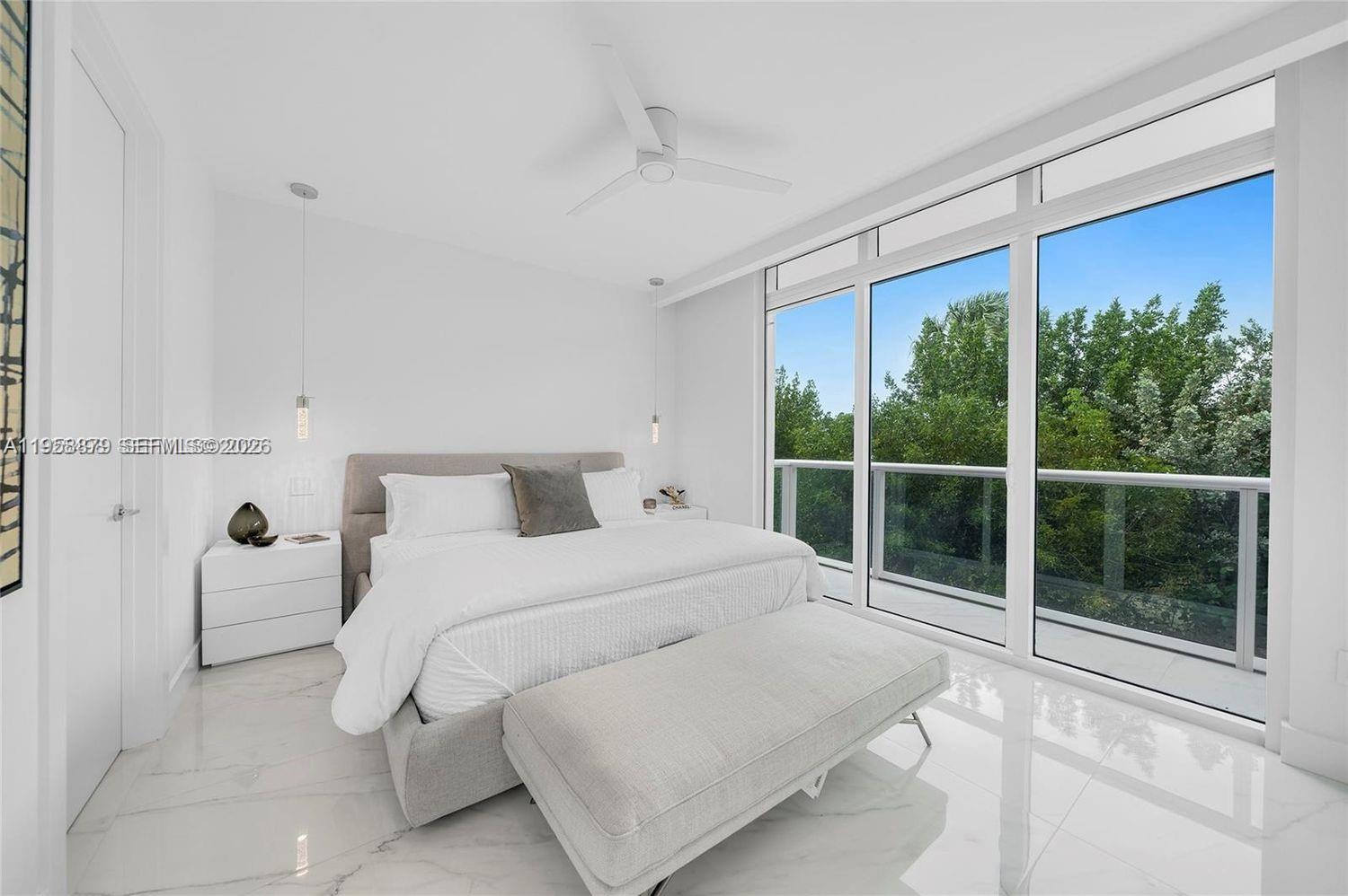 100 South Pointe Drive, Unit TH13 Miami Beach, FL 33139 - Photo 24 of 69 a bedroom with a large bed and a large window