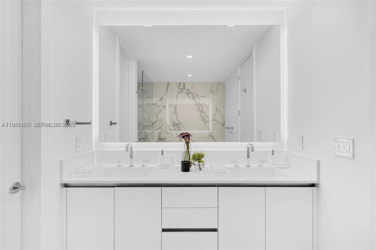 100 South Pointe Drive, Unit TH13 Miami Beach, FL 33139 - Photo 29 of 69 a bathroom with a sink and a mirror