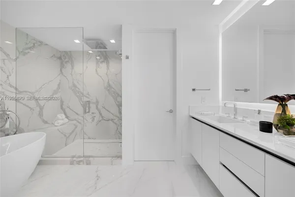 a bathroom with a toilet sink vanity and mirror