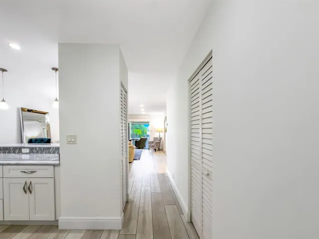 a view of hallway with livingroom and furniture
